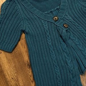 Blue, knitted, over sweater.
